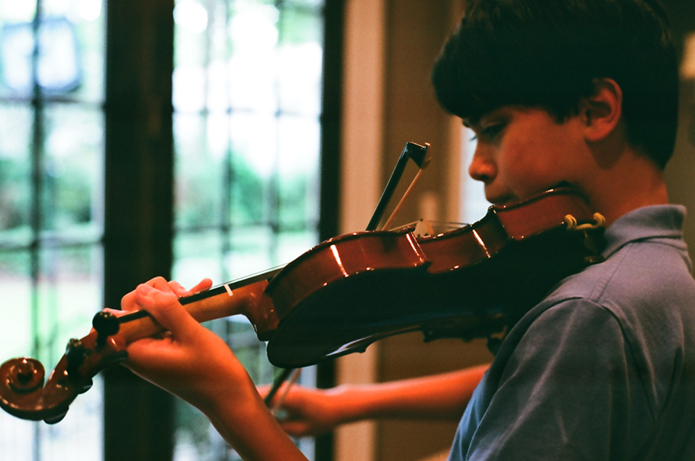 blue shirt violin and window