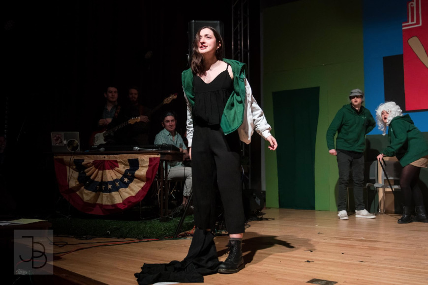 comedian Amara Leonard performing improv on a stage