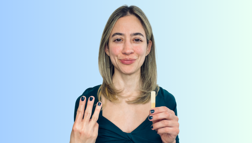 Image of Liz Ramirez holding the number 3 and a clarinet reed