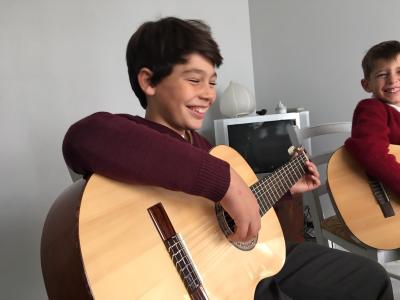 smiling boys with guitars