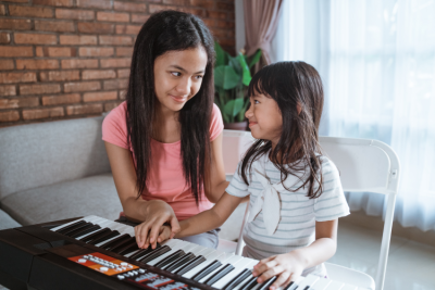Child enjoying learning to play piano.