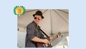 Image of Derek Gonzales playing the guitar on stage