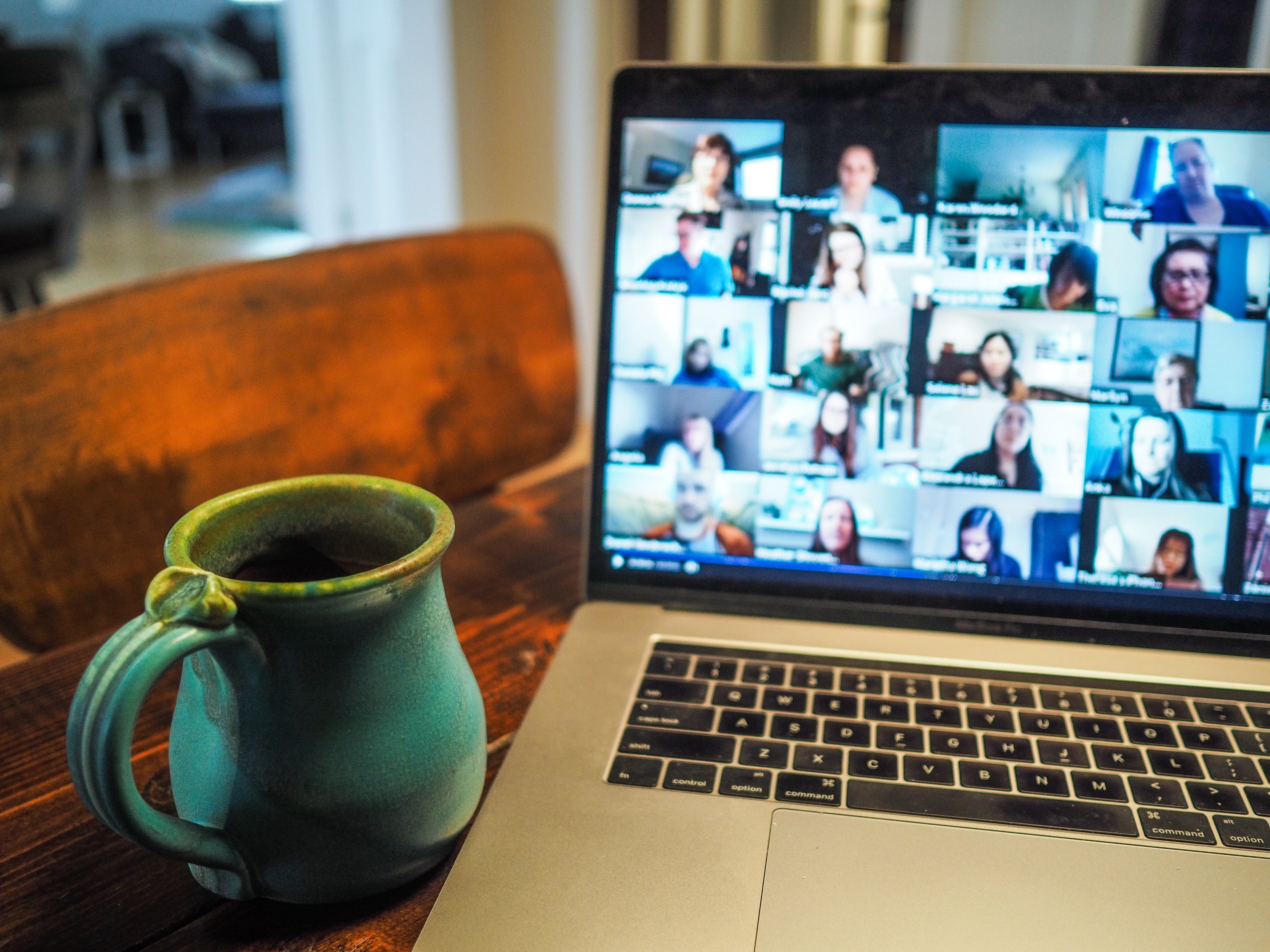 person on zoom call with tea next to computer